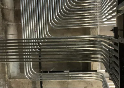 Stainless steel pipes in a concrete building.
